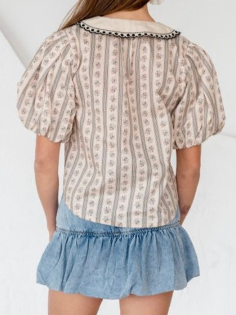Beige printed blouse with embroidered flaps neck detail