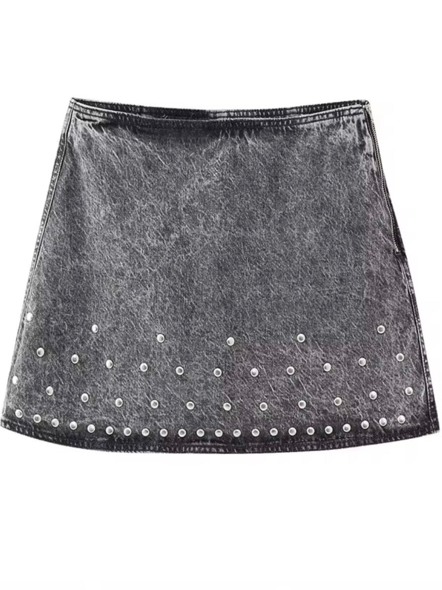 Black jeans and studded set of jacket and mini skirt