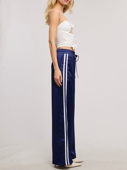 Sporty Satin effect track pants with stripes