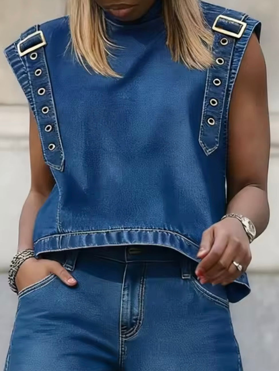 Blue jeans with gold metallic detailing sleeveless top
