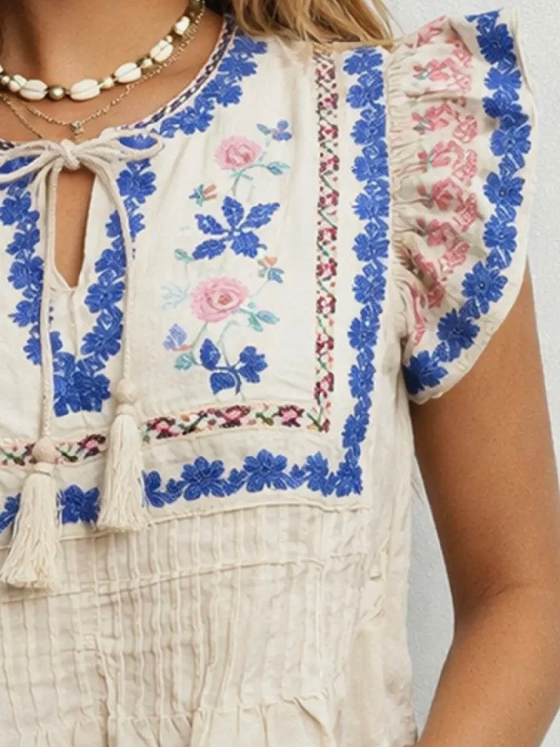 Beige embroidered floral ruffled sleeveless top