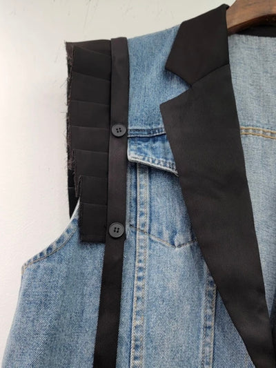 Blue jeans and black vest