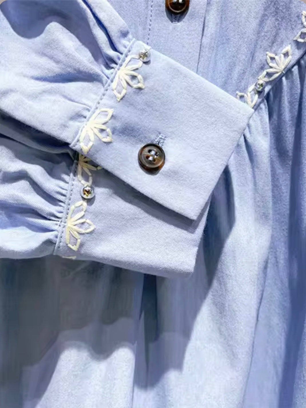 Light blue and white embroidered floral details shirt