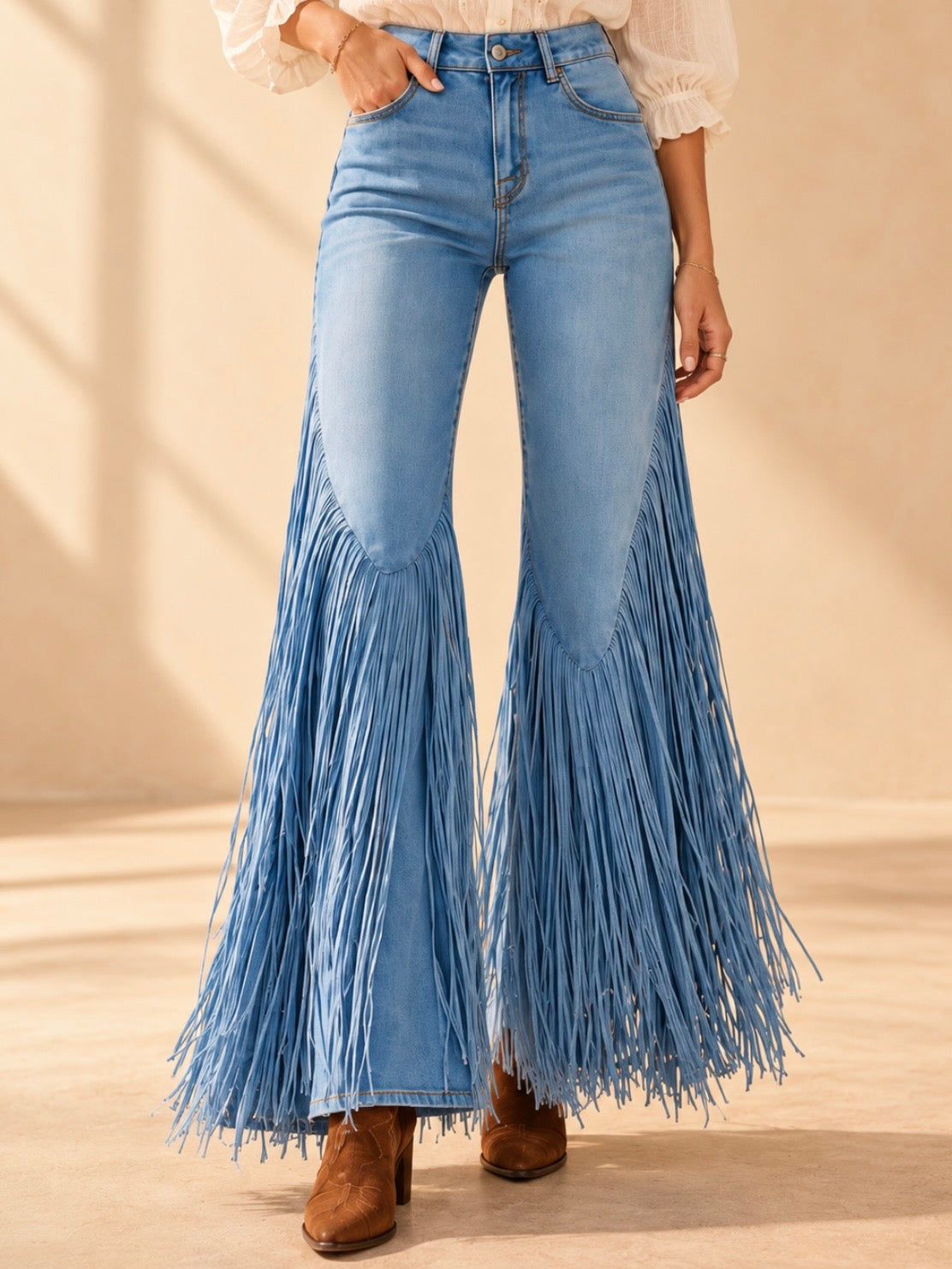 Light blue high-rise flared jeans with long fringe