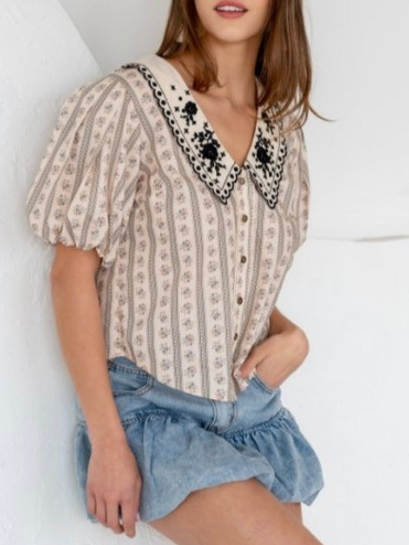 Beige printed blouse with embroidered flaps neck detail