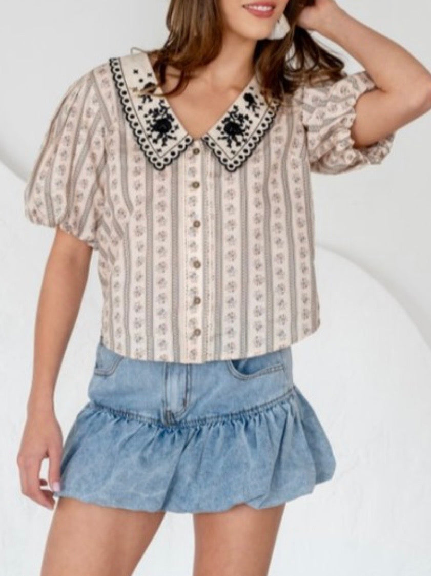Beige printed blouse with embroidered flaps neck detail
