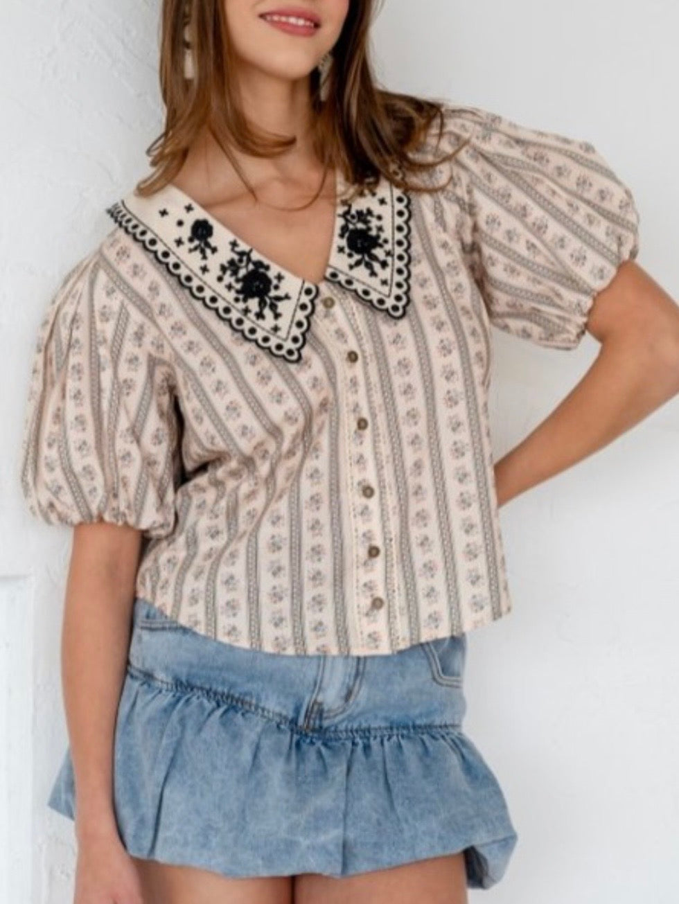 Beige printed blouse with embroidered flaps neck detail