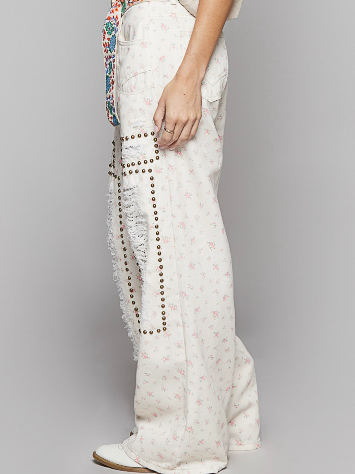 Beige floral print distressed studded pants