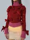 Red and fuchsia turtleneck bows sweater