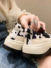 Brown and white cow print platform straps sneakers