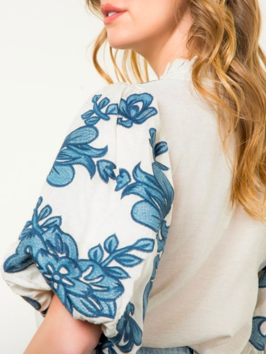 White and blue embroidered floral texture top