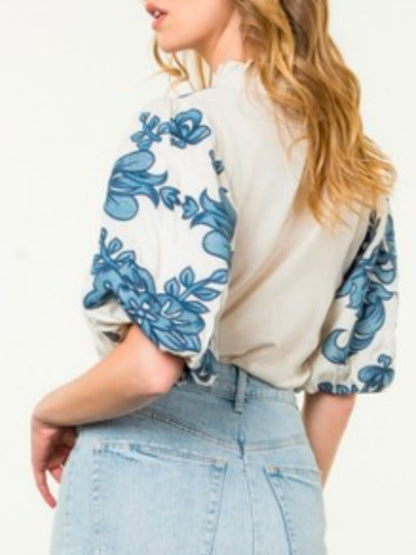 White and blue embroidered floral texture top