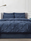 bedroom with 8 piece blue pleated bedding set