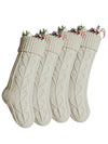 four beige knitting wool Christmas socks with Christmas decorations