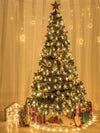 Christmas tree decorated with gold colored led lights in the shape of snowflakes