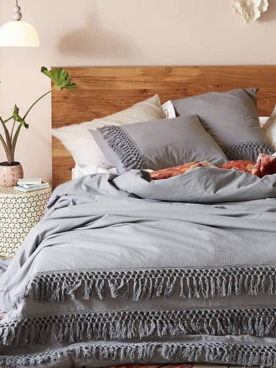 The bed in the room is decorated with a Boho Gray duvet, it has two pillowcases and a duvet cover.