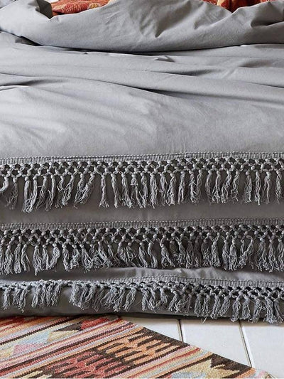gray boho quilt with tassels